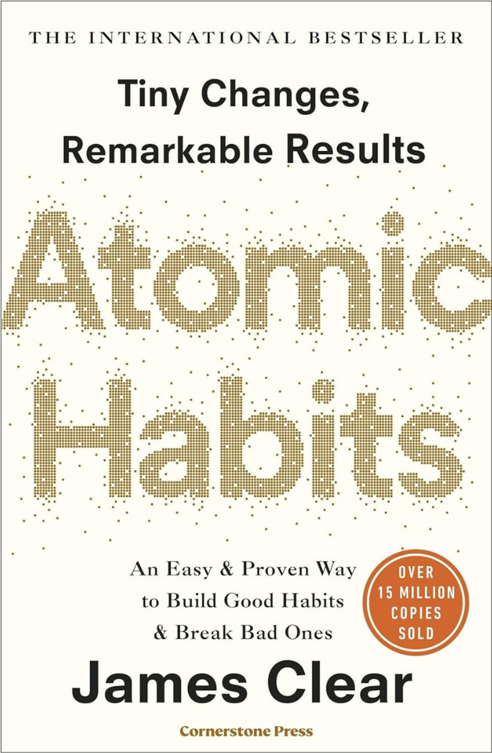 Atomic Habits by James Clear paperback cover on desk with stationery
