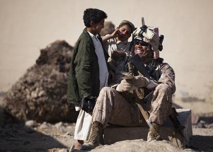 US Marine practices Pashto with Afghan boys in Afghanistan Canvas Art - Stocktrek Images Canvas Art