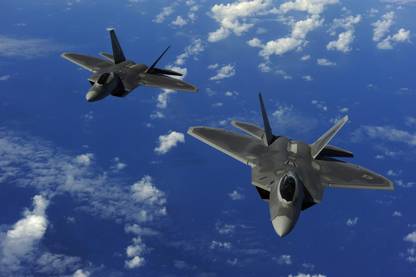 US Air Force F-22 Raptors in flight near Guam Canvas Art - Stocktrek Images (34 x 23) Canvas Art