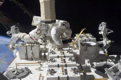 Astronaut working on the International Space Station during a spacewalk Canvas Art - Stocktrek Images (34 x 23) Canvas Art