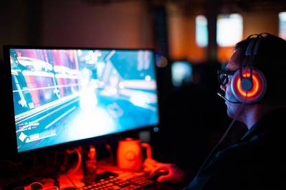 person using computer playing fps game Paper Print
