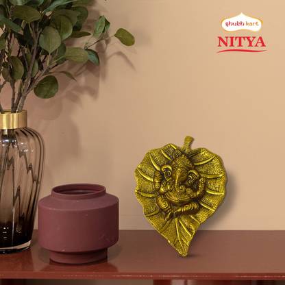Shubhkart Nitya Ganesh on Paan Leaf Showpiece – 141 g Decorative Showpiece – 17.5 cm  (Metal, Yellow) at Rs. 99