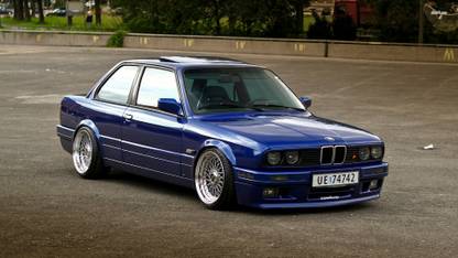 Athah Front side view of a blue BMW E30 Poster Paper Print