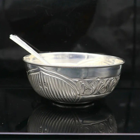 Serve with grace or offer with devotion. This silver bowl features exquisite floral embossing, making it a sophisticated choice for ceremonial use or luxury home decor.