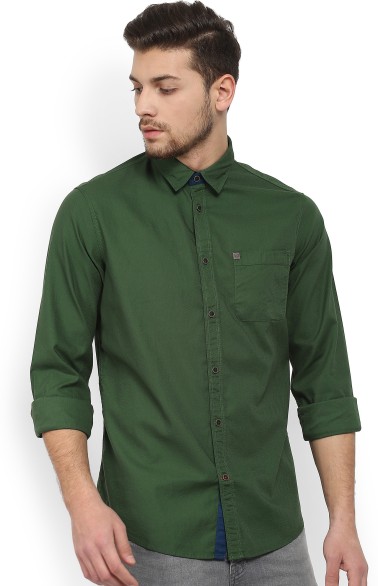 dark green shirt with dark blue jeans