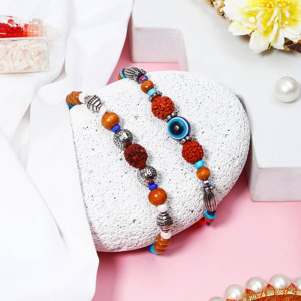 Thread Set Of 2 Wooden Rudraksha & Evil Eye Charm Bracelet Rakhi Set With Greeting Card Assorted Rakhi, Greeting Card, Chawal Roli Pack Set by ARCHIES