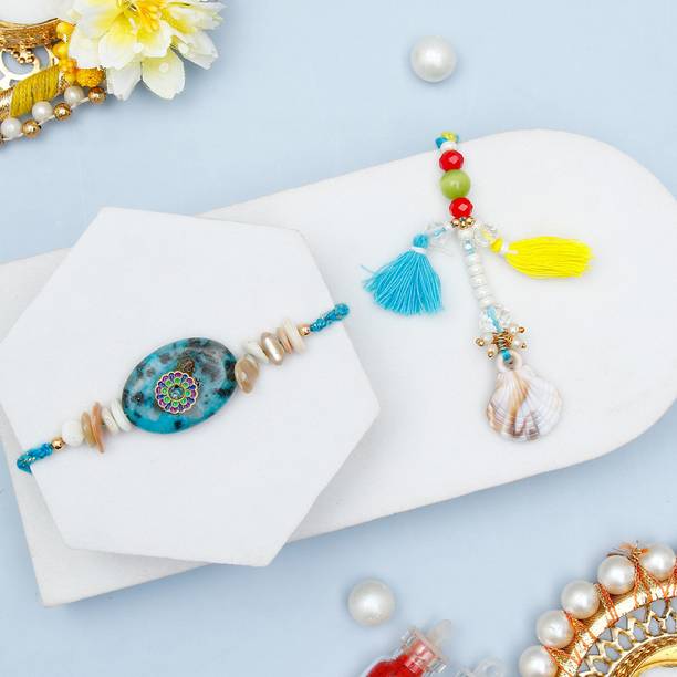 Thread Stone Rakhi & Shell Tassel Lumba Rakhi Set For Bhaiya Bhabhi With Greeting Card Assorted Rakhi, Greeting Card, Chawal Roli Pack Set by ARCHIES