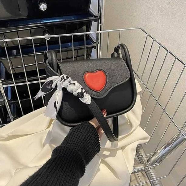 Black Women Sling Bag women's shoulder sling bag with a heart design and a scarf detail.