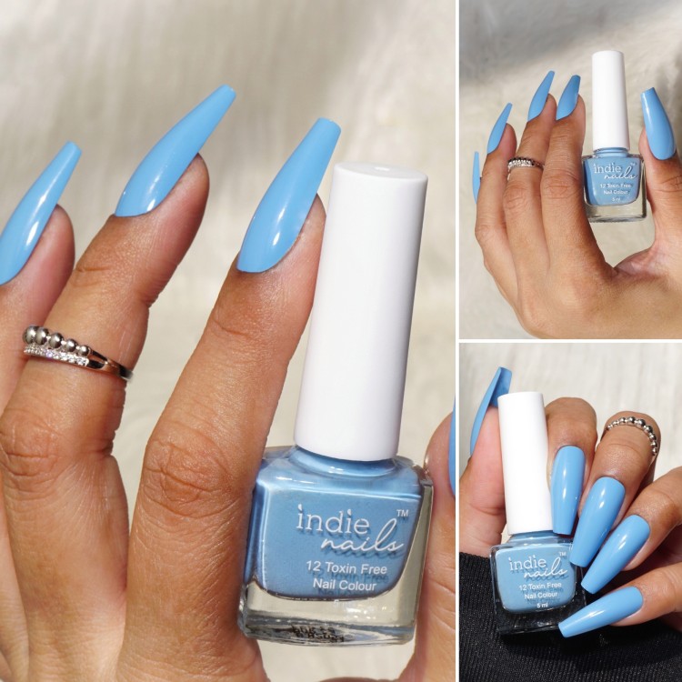 Premium Photo | A woman's nails with blue nail art and clouds