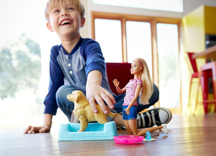 Little boy playing with barbie dolls store
