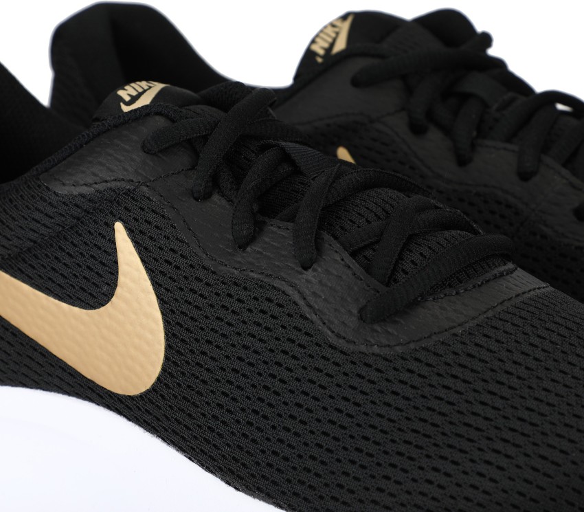 Black and hotsell gold nike tanjun