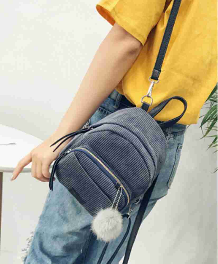 Mini backpack with pom pom best sale