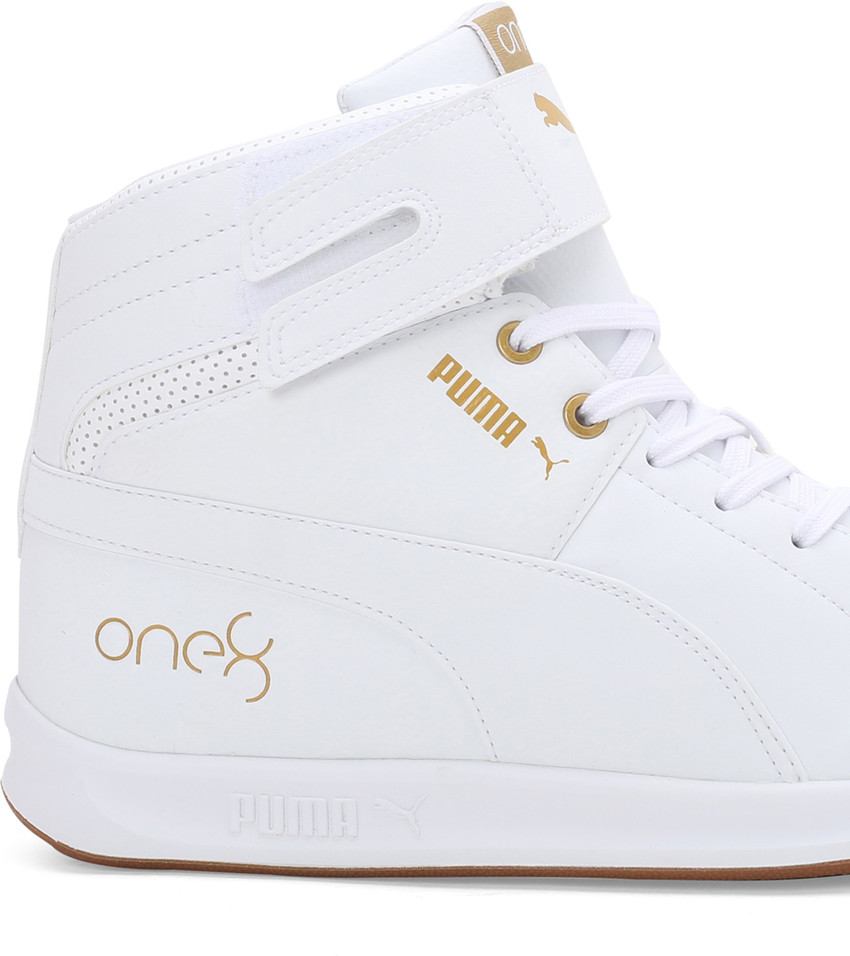 gold and white high top pumas