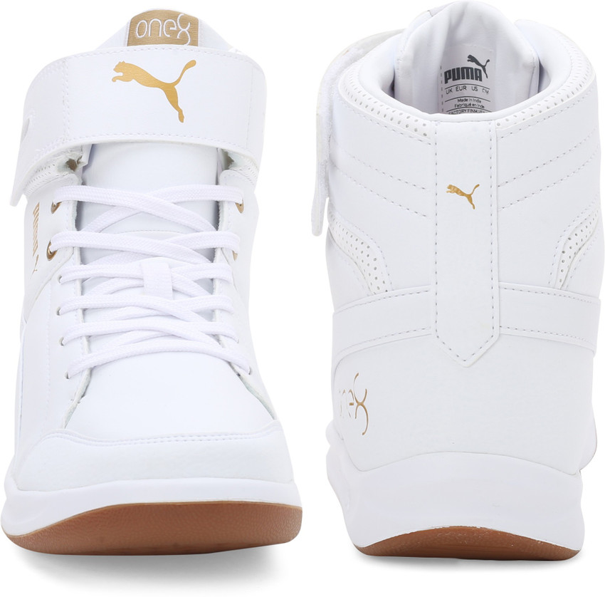 gold and white high top pumas