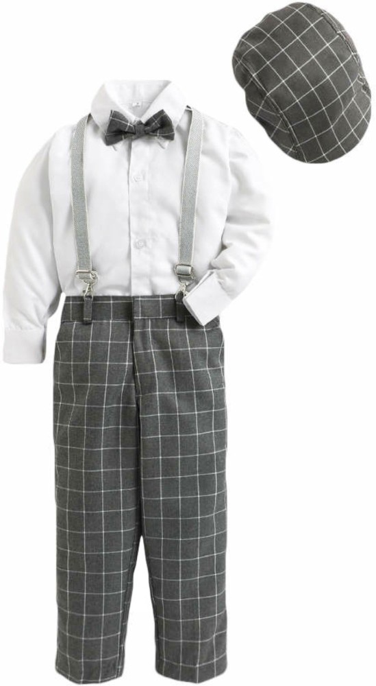 Stylish child boy in trendy black trousers with suspenders white shirt and  hat posing on yellow background Stock Photo  Alamy