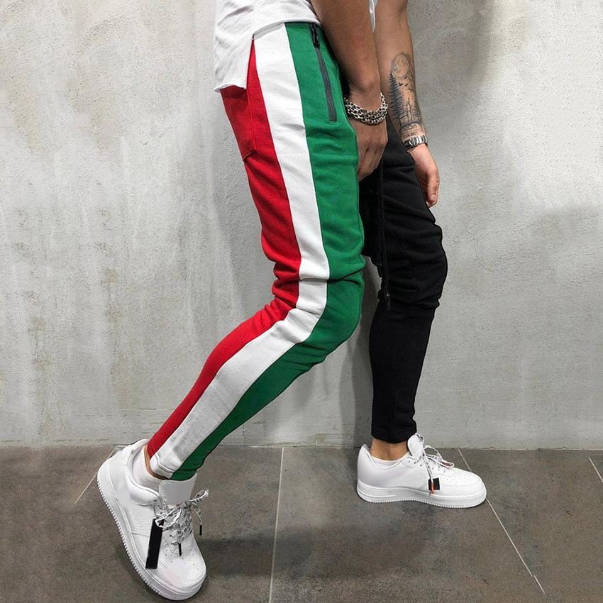 Men's green track store pants with red stripe
