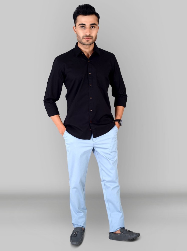 Attractive White Man In Black Shirt And Blue Pants Stands On A Dark  Background Stock Photo  Download Image Now  iStock