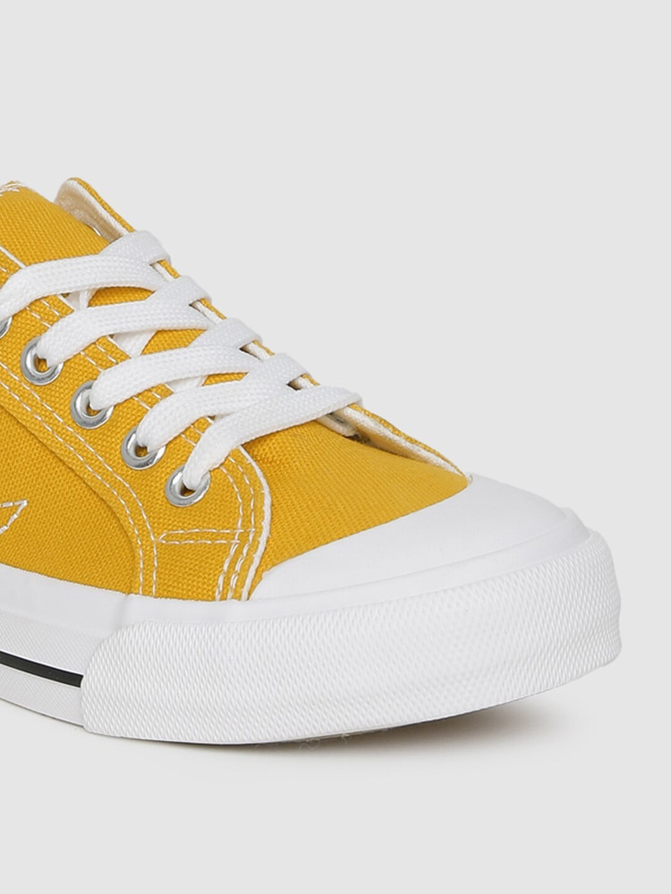 Mustard yellow tennis shoes top