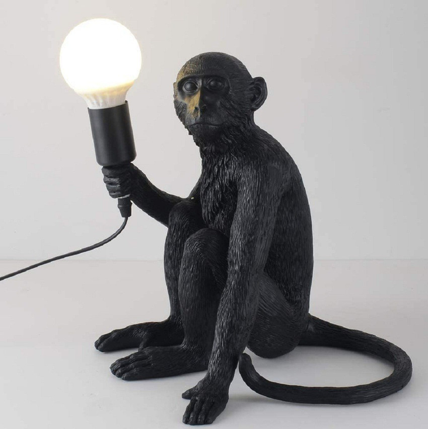 Monkey holding top light bulb lamp
