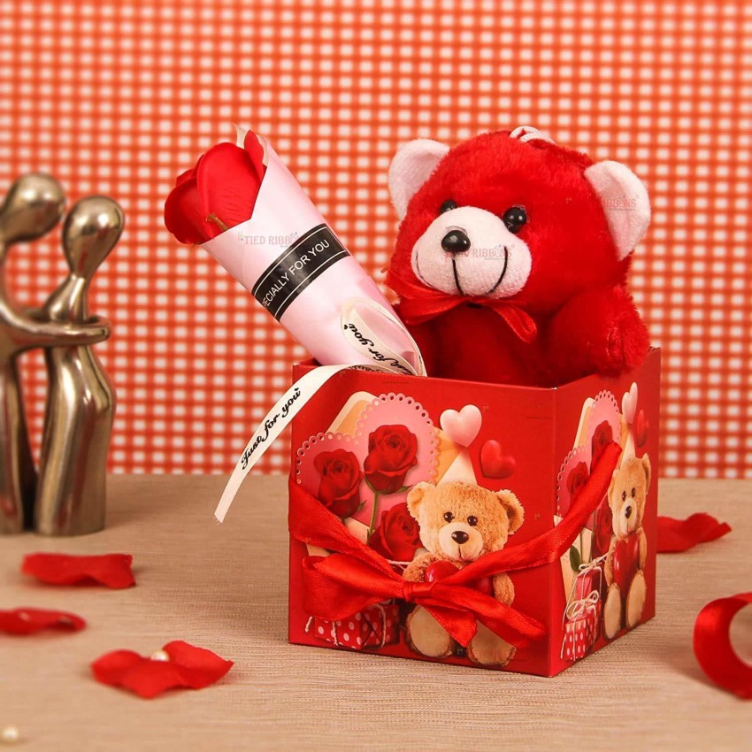 Cute teddy bear in red roses. Gift for a girl, woman. Valentine's
