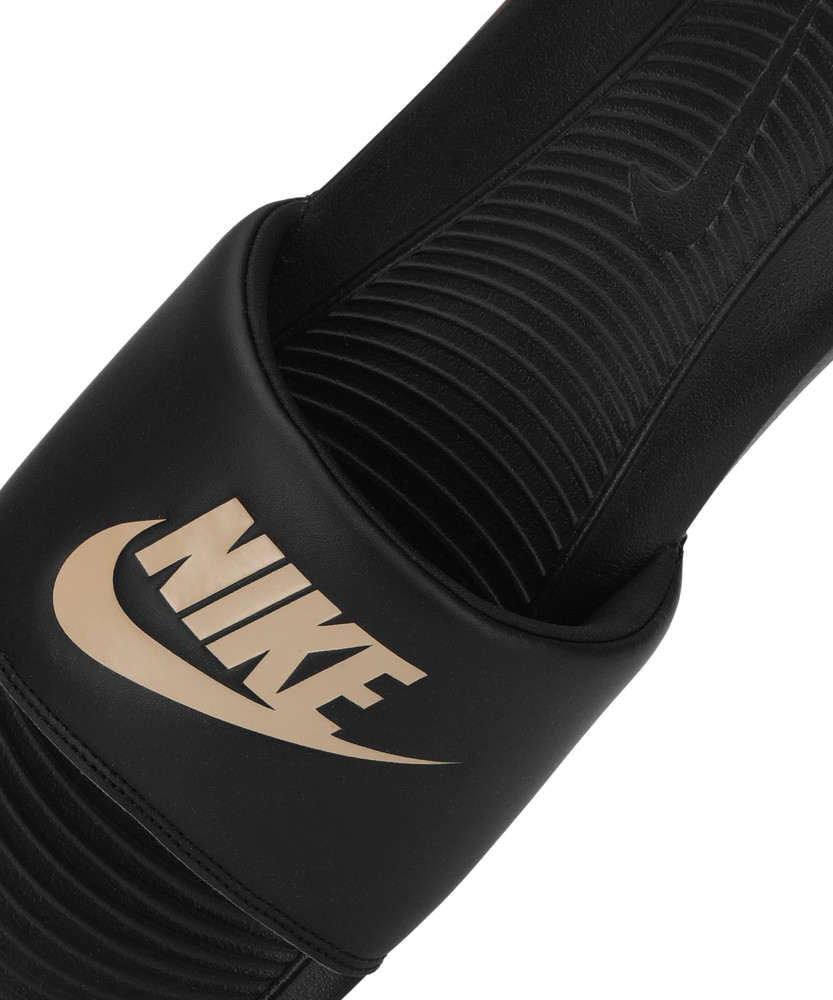 Gold and black nike slides discount
