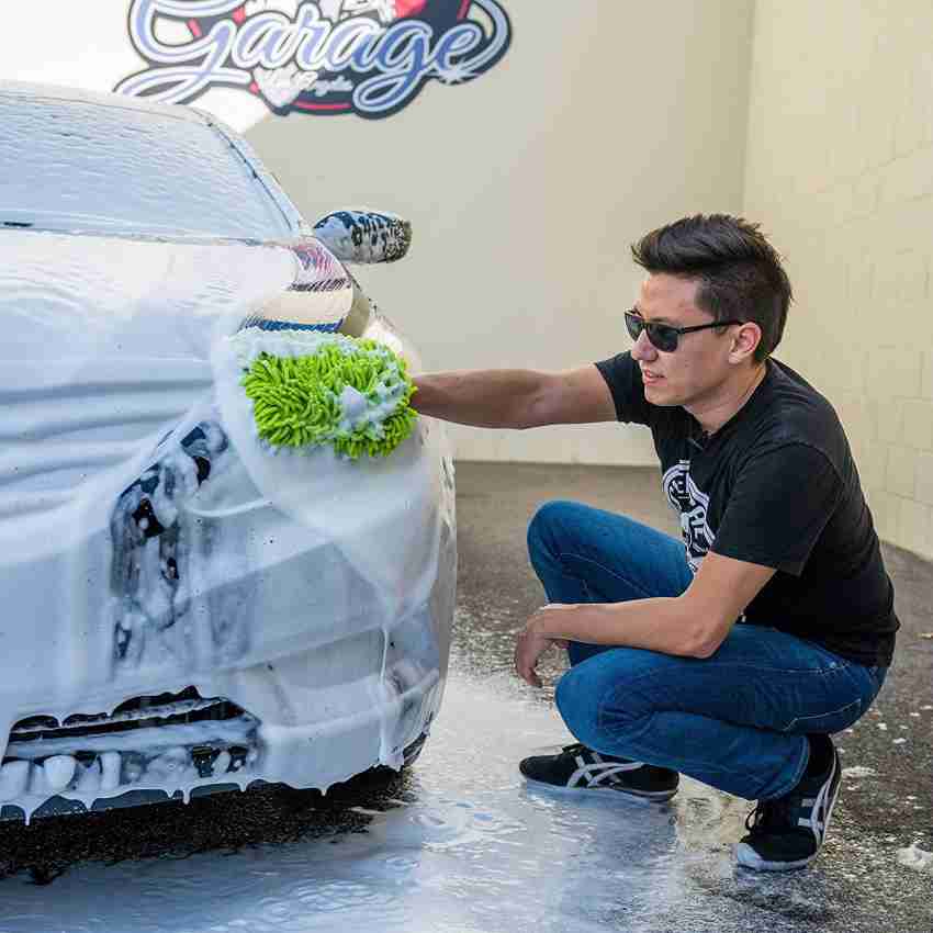 Premium Photo  Man washing car with car wash - pressure washer shampoo  sponges and microfiber car towels