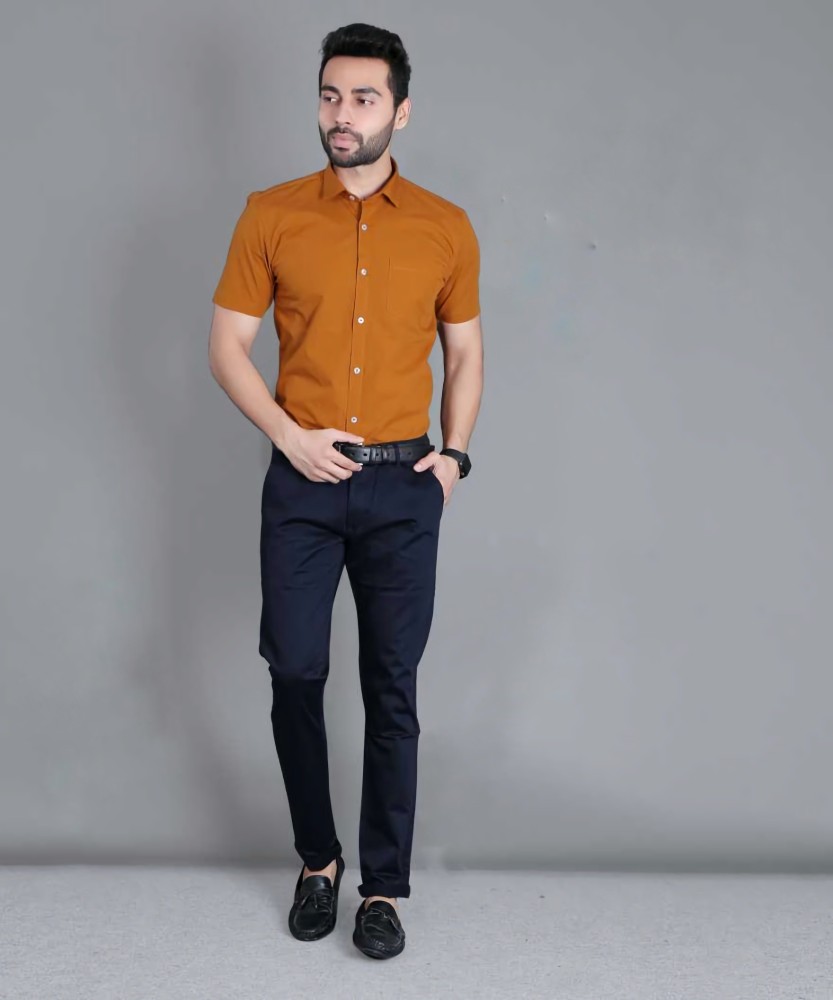 Man Working Outside Dressing In A Light Orange Patterned Shirt Gray Pants  Leather Shoes A Young Guy Is Standing By An Old Fashion Window In The  Corner Looking Down Working On A