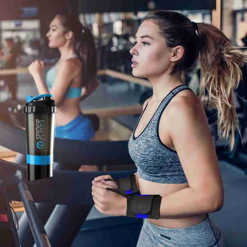 Fitness woman with shaker in gym, drinking water. Athletic girl