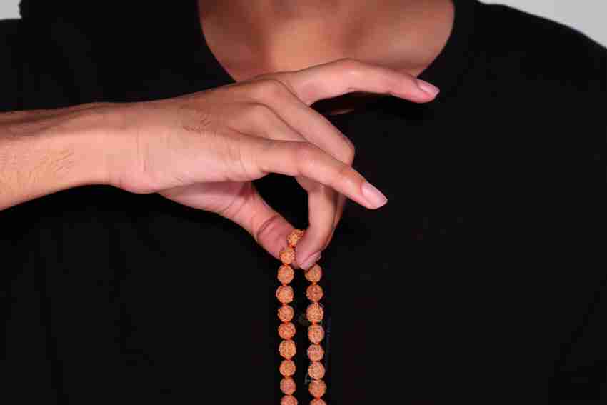 Hand Holding Indian Rudraksha / Japa Mala Prayer Beads Over