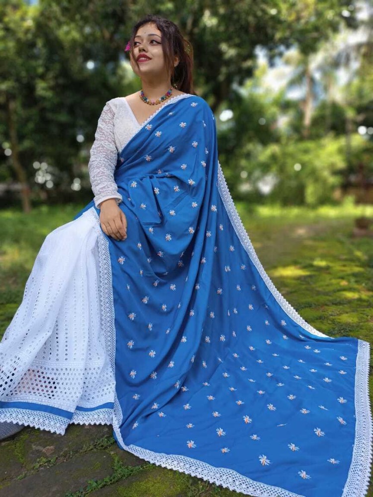 shreya-jain-in-chic-white-accordion-pleated-solid-saree -with-high-neck-sleeveless-printed-blue-blouse - K4 Fashion