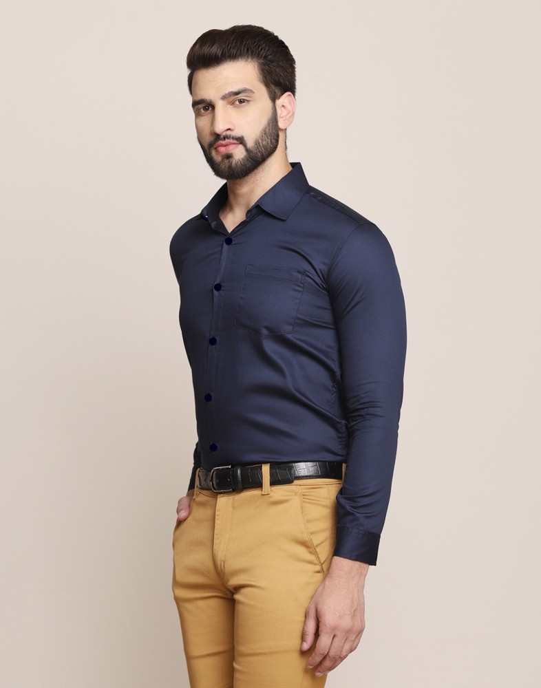 Man in blue dress shirt and white pants holding black sunglasses photo   Free Tehran Image on Unsplash