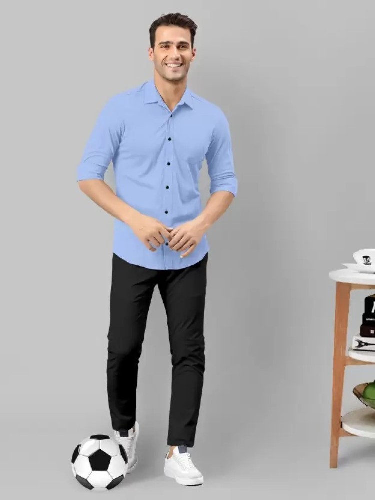 Premium Photo  Boy teenager in a school uniform on a white background the  schoolboy demonstrates black trousers with a belt a jacket a blue shirt  vertical photo