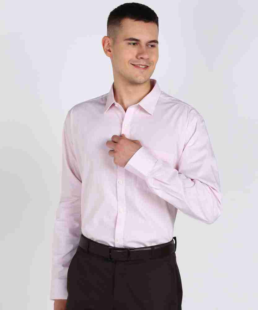 young man in a pink shirt and dress pants Stock Photo