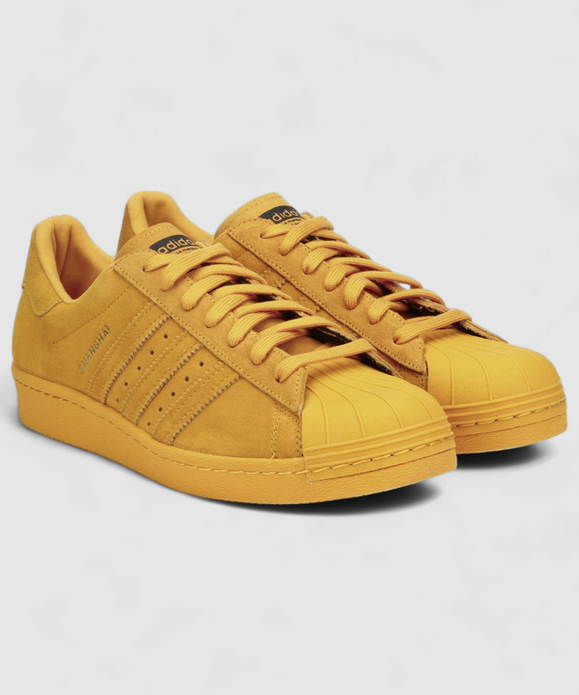 yellow adidas superstar