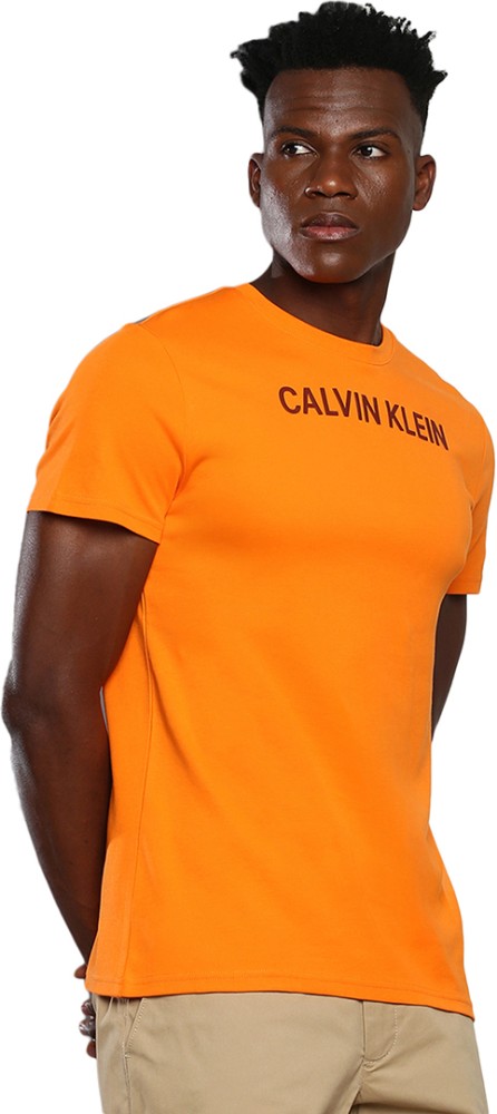 Calvin Klein Jeans Typography India Men T-Shirt Round Online at Orange Calvin Typography Prices Round Best - Klein Jeans in Neck Buy Neck Men T-Shirt Orange