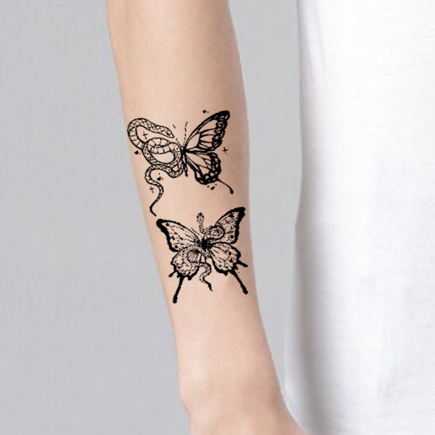 Minimalistic one line butterfly tattoo located behind