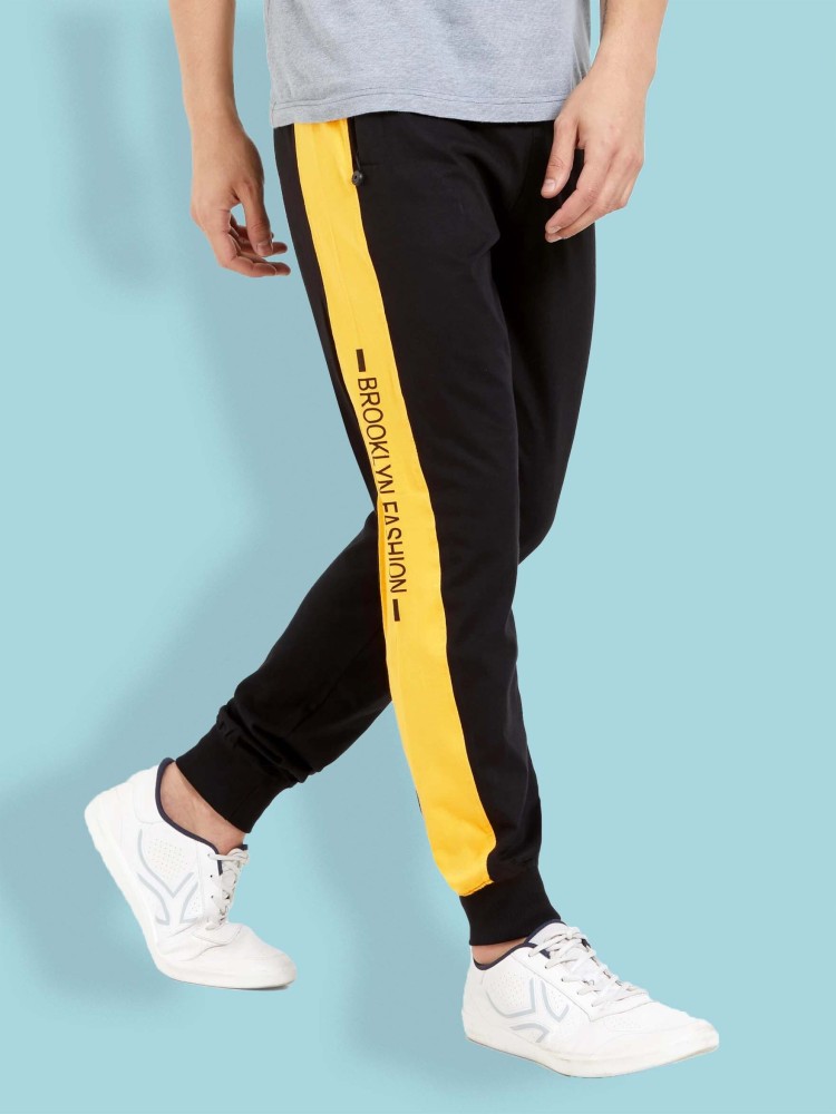 Black and yellow track pants on sale